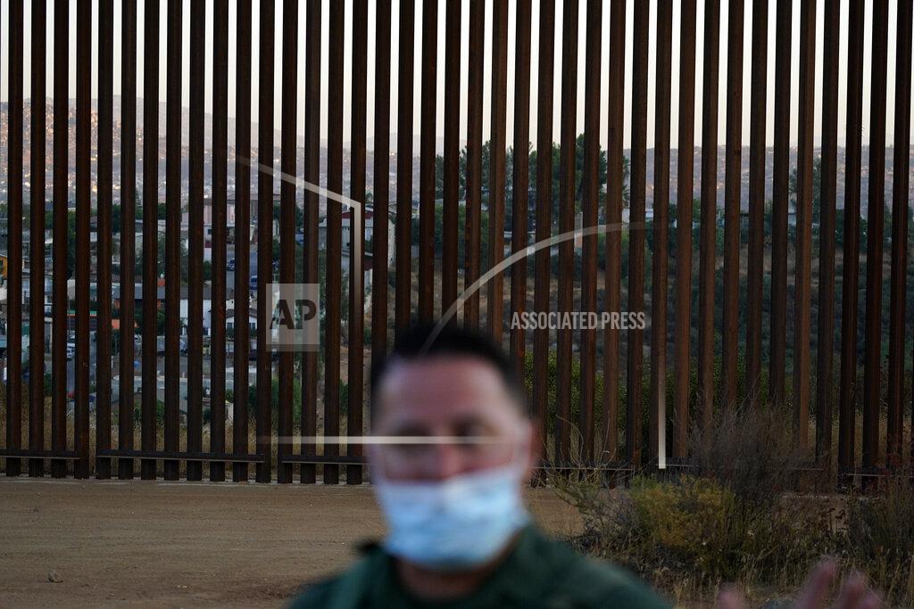 Gregory Bull Border Patrol agent Justin Castrejon speaks in front of newly replaced border wall sections Thursday, Sept. 24, 2020, near Tecate, Calif. Top Trump administration officials will visit South Texas five days before Election Day to announce they have completed 400 miles of U.S.-Mexico border wall, attempting to show progress on perhaps the president's best-known campaign promise four years ago. But most of the wall went up in areas that already had smaller barriers. (AP Photo/Gregory Bull)