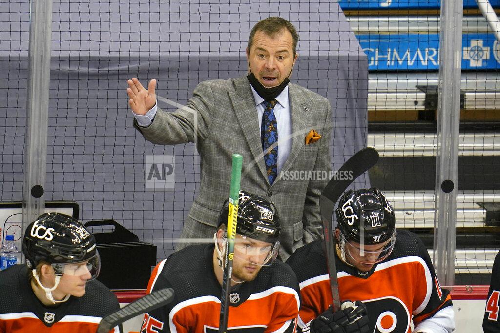Gene J. Puskar Philadelphia Flyers head coach Alain Vigneault, top, makes a point to the referee during the first period of an NHL hockey game against the Pittsburgh Penguins in Pittsburgh, Thursday, April 15, 2021. (AP Photo/Gene J. Puskar)