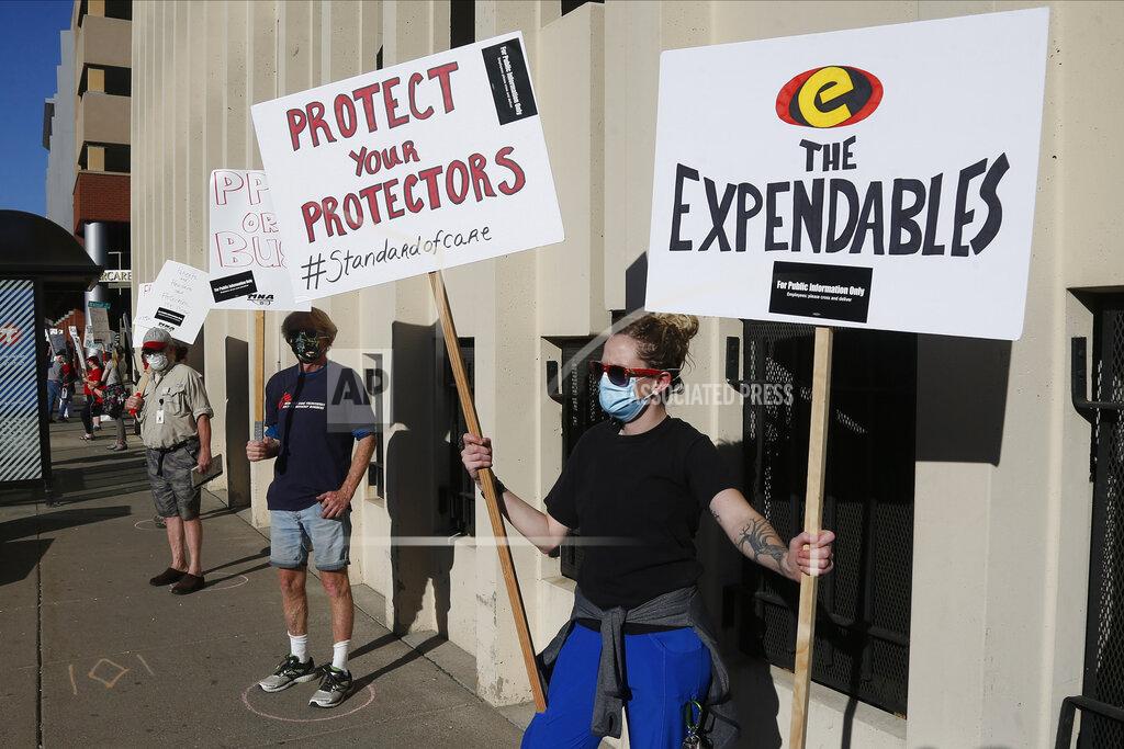 Jim Mone Nurses picket outside United Hospital Wednesday, May 20, 2020 in St. Paul, Minn. as they seek a say in worker protections, increased personal protection resources with higher safety standards, and an end to retaliation against workers who have tried to protect themselves from COVID-19. (AP Photo/Jim Mone)