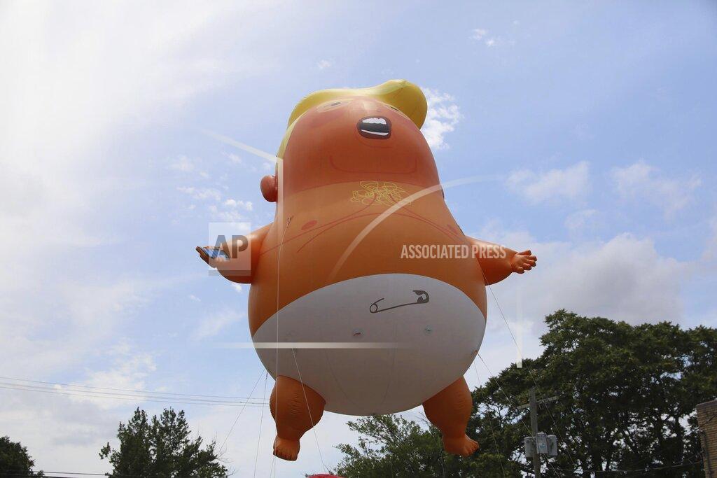 Tom Gilbert People float a "Baby Trump" balloon in Tulsa, Okla., on Saturday, June 20, 2020, ahead of President Donald Trump's campaign rally in the city. The organizers are raising money for the Vernon AME Baptist Church. (Tom Gilbert/Tulsa World via AP)