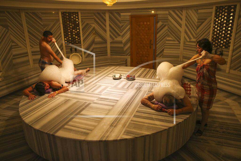Emrah Gurel German couple Renate Malzahn and her husband, Harry Malzahn enjoy a Turkish bath in Antalya, southern Turkey, Saturday, June 19, 2021. Hotels in Turkey's Antalya region, a destination beloved by holidaymakers, are preparing to finally resume operations as they expect the return of international tourists after months of setbacks caused by the pandemic that halted travel. (AP Photo/Emrah Gurel)
