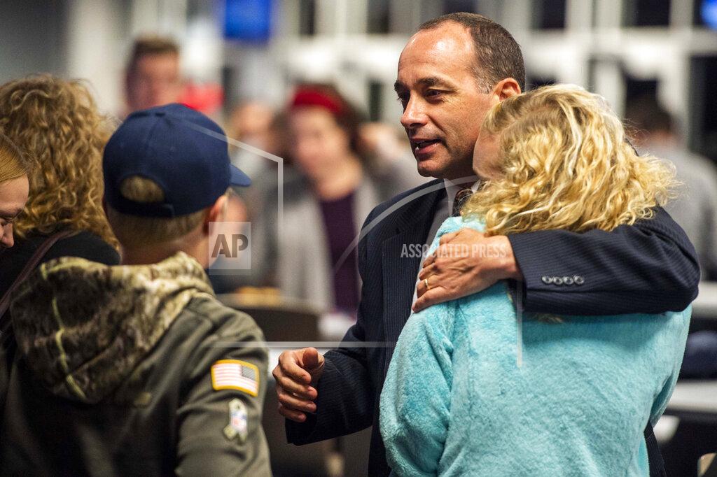 Kendall Warner U.S. House candidate Bob Good for the 5th Congressional District hugs supporters during a watch party at Liberty University in Lynchburg, Va., Tuesday, Nov. 3, 2020. (Kendall Warner/The News & Advance via AP)