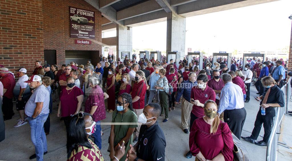 Mark Wallheiser Fans line up prior to the doors opening for the public celebration of life for longtime Florida State University football coach Bobby Bowden at the Tucker Civic Center Saturday, Aug. 14, 2021, in Tallahassee, Fla. The patriarch of Florida State football and the coach who built a dynasty from scratch died at 91 on Sunday at his home in Tallahassee. (AP Photo/Mark Wallheiser)