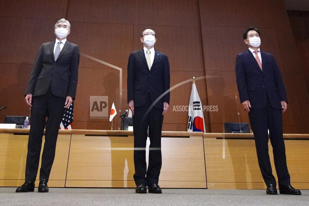 Eugene Hoshiko Japanese Foreign Ministry's Director-General of the Asian and Oceanian Affairs Bureau Takehiro Funakoshi, center, U.S. Special Representative for North Korea, Sung Kim, left, and South Korea's Special Representative for Korean Peninsula Peace and Security Affairs Noh Kyu-duk pose for photographers during their trilateral meeting on North Korean issue at Foreign Ministry Tuesday, Sept. 14, 2021 n Tokyo. (AP Photo/Eugene Hoshiko)