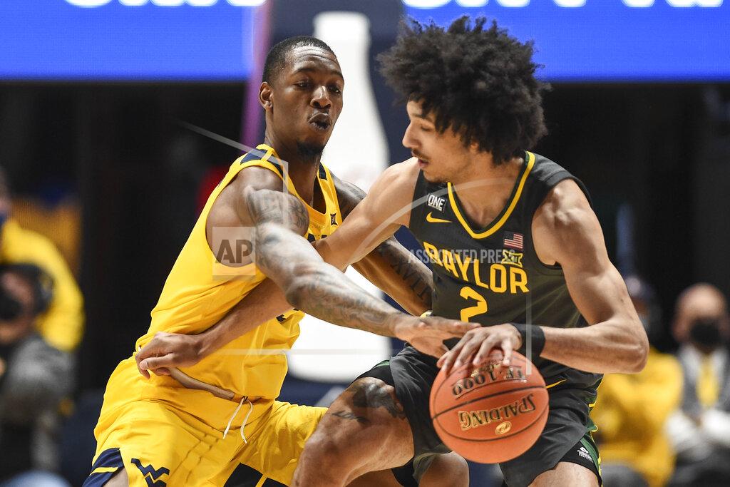 William Wotring West Virginia forward Gabe Osabuohien (3) attempts to steal the ball from Baylor guard Kendall Brown (2) during the first half of an NCAA college basketball game in Morgantown, W.Va., Tuesday, Jan. 18, 2022. (William Wotring)