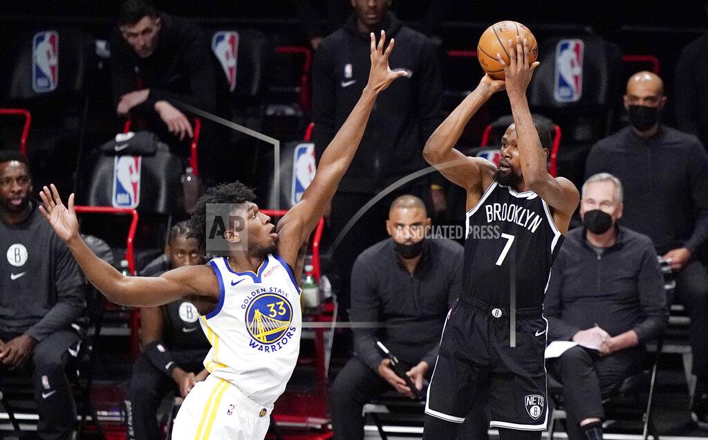 Kathy Willens Golden State Warriors center James Wiseman (33) defends as Brooklyn Nets forward Kevin Durant (7) looks to shoot during the first quarter of an opening night NBA basketball game, Tuesday, Dec. 22, 2020, in New York. (AP Photo/Kathy Willens)
