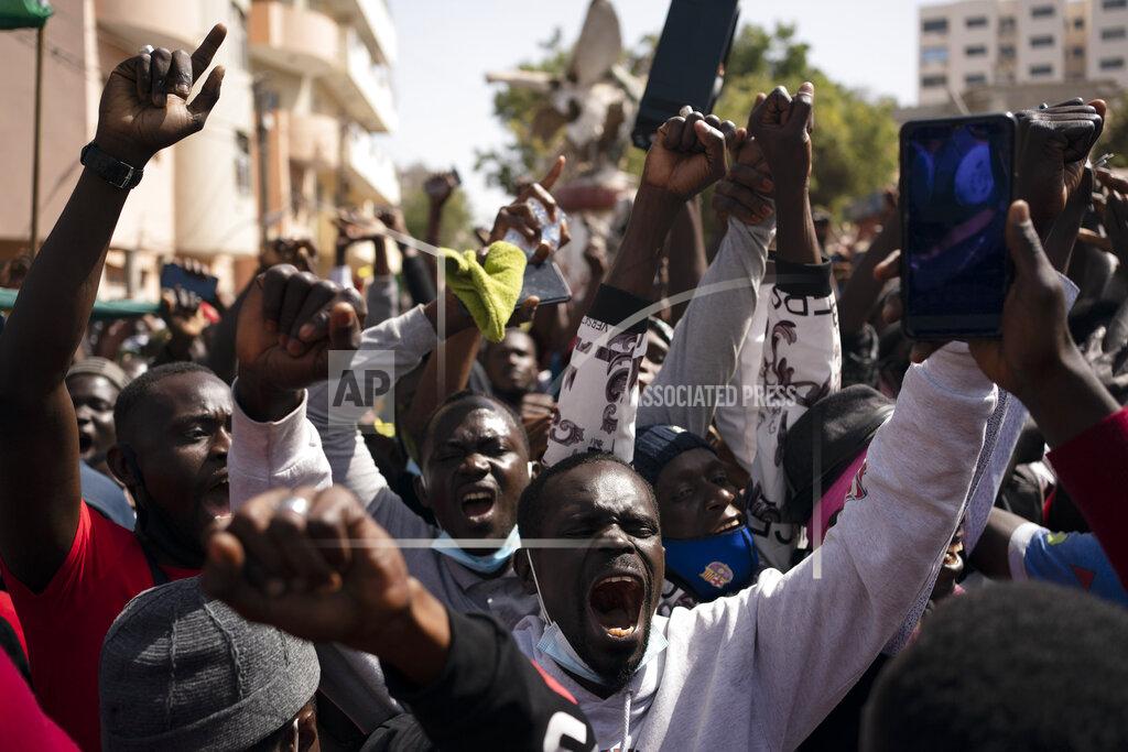Leo Correa Demonstrators shout slogans during a protest against the arrest of opposition leader and former presidential candidate Ousmane Sonko near the Justice Palace of Dakar, Senegal, Monday, March 8, 2021. A Senegalese court cleared the way Monday for Sonko's release pending his rape trial in a case that already has sparked deadly protests and threatened to erode the country's reputation as one of West Africa's most stable democracies. (AP Photo/Leo Correa)