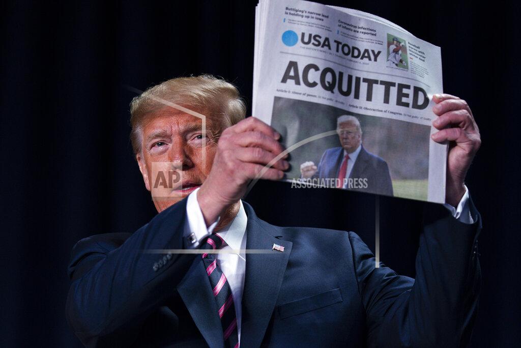 Evan Vucci FILE - In this Feb. 6, 2020, file photo, President Donald Trump holds up a newspaper with the headline that reads "ACQUITTED" at the 68th annual National Prayer Breakfast, at the Washington Hilton in Washington. (AP Photo/ Evan Vucci, File)