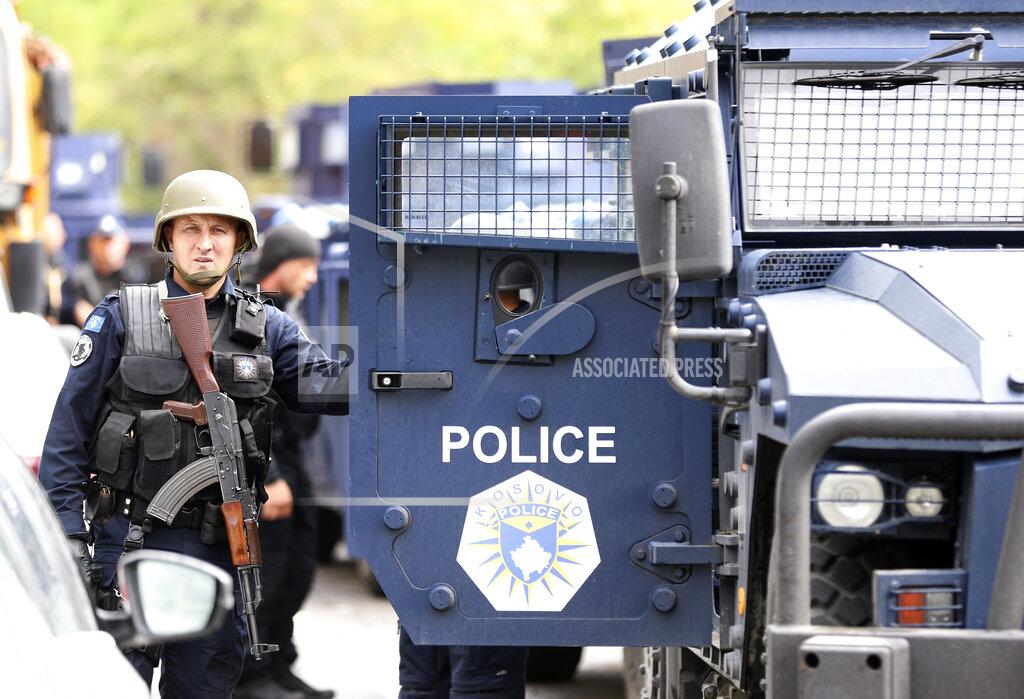 Bojan Slavkovic Kosovo special police with armored vehicles stand on the road near the northern Kosovo border crossing of Jarinje, Monday, Sept. 20, 2021. Tensions have soared on the border between Kosovo and Serbia as Pristina authorities started implementing a rule to remove Serbian license plates from cars entering Kosovo. Kosovo special police with armored vehicles were deployed Monday on the tense border as hundreds of Kosovo Serbs reportedly drove there in their cars to protest the move. (AP Photo/Bojan Slavkovic)