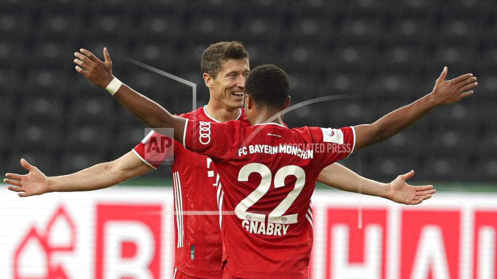 Michael Sohn Bayern's Robert Lewandowski, left, celebrates after scoring his side's third goal with teammate Serge Gnabry during the German soccer cup (DFB Pokal) final match between Bayer 04 Leverkusen and FC Bayern Munich in Berlin, Germany, Saturday, July 4, 2020. (AP Photo/Michael Sohn)