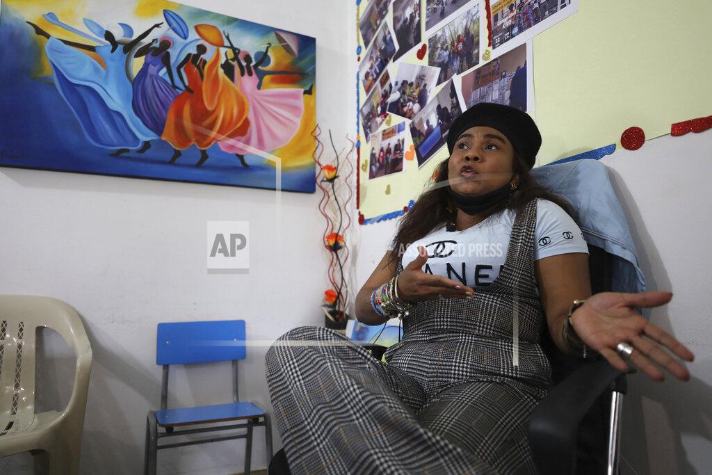 Fernando Vergara Community leader Luz Nelly Santana, whose life has been threatened by illegal armed groups, talks during an interview in Bogota, Colombia, Thursday, Dec. 17, 2020. Santana and her daughter survived a massacre where 35 people were killed during a street party and decided to flee to the capital where she has lived ever since. (AP Photo/Fernando Vergara)