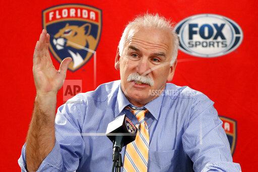 FILE - In this Jan. 21, 2020, file photo, Florida Panthers head coach and former Chicago Blackhawks coach, Joel Quenneville, responds to a question during his first visit back to Chicago as a head coach before an NHL hockey game between the Blackhawks and Panthers. The Blackhawks are holding a briefing Tuesday, Oct. 26, 2021, to discuss the findings of an investigation into allegations that an assistant coach sexually assaulted a player in 2010. The Blackhawks pledged to release the findings of the investigation, which general manager Stan Bowman, former coach Quenneville and others who were in the organization at the time agreed to cooperate with. (AP Photo/Charles Rex Arbogast, File)
