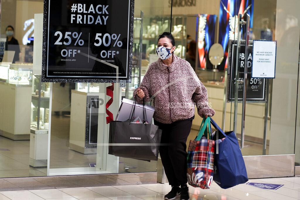 Ringo H.w. Chiu A Black Friday shopper wearing a face mask carries bags at the Glendale Galleria in Glendale, Calif., Friday, Nov. 27, 2020. (AP Photo/Ringo H.W. Chiu)