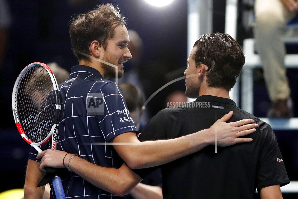 Frank Augstein Daniil Medvedev of Russia, left, puts his arm around Dominic Thiem of Austria after he wins their singles final tennis match at the ATP World Finals tennis tournament at the O2 arena in London, Sunday, Nov. 22, 2020. (AP Photo/Frank Augstein)
