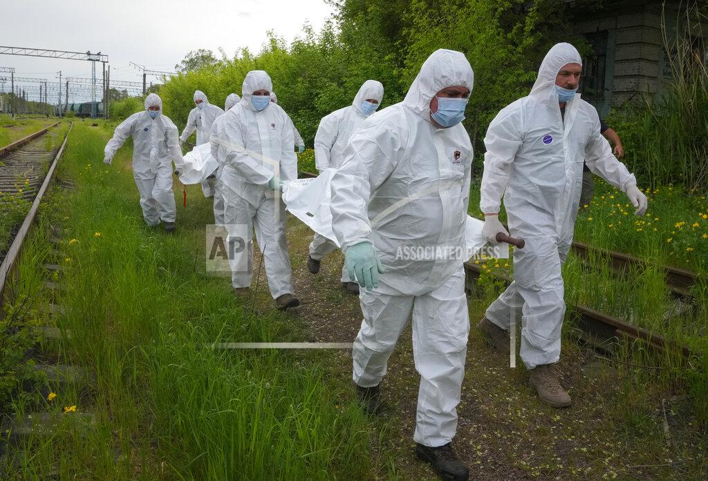 Efrem Lukatsky Ukrainian servicemen carry bodies of Russian soldiers to load into a railway refrigerator carriage in Kyiv, Ukraine, Friday, May 13, 2022. (AP Photo/Efrem Lukatsky)