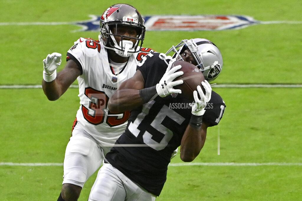 David Becker Las Vegas Raiders wide receiver Nelson Agholor (15) catches a pass over Tampa Bay Buccaneers cornerback Jamel Dean (35) during the second half of an NFL football game, Sunday, Oct. 25, 2020, in Las Vegas. (AP Photo/David Becker)