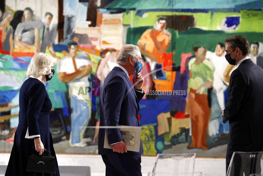 Yorgos Karahalis Greece's Prime Minister Kyriakos Mitsotakis, right, and Britain's Prince Charles, center, with his wife Camilla, the Duchess of Cornwall, left, visit Greece's newly renovated National Gallery in Athens, Wednesday, March 24, 2021. Greece on Wednesday kicked off two days of celebrations to mark the bicentenary of the start of the country's war of independence, although events are far more muted than originally planned due to the pandemic. (AP Photo/Yorgos Karahalis)