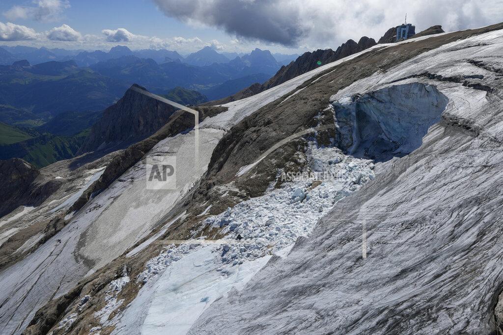 Luca Bruno A view taken from a rescue helicopter of the Punta Rocca glacier near Canazei, in the Italian Alps in northern Italy, Tuesday, July 5, 2022, two days after a huge chunk of the glacier broke loose, sending an avalanche of ice, snow, and rocks onto hikers. Italy was enduring a prolonged heat wave before a massive piece of the Alpine glacier broke off and killed hikers on Sunday and experts say climate change will make those hot, destabilizing conditions more common. (AP Photo/Luca Bruno)