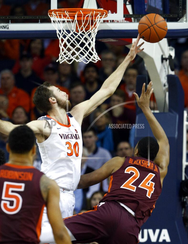 Steve Helber Virginia forward Jay Huff (30) blocks s shot by Virginia Tech forward Kerry Blackshear Jr. (24) during the first half of an NCAA college basketball game in Charlottesville, Va., Tuesday, Jan. 15, 2019. (AP Photo/Steve Helber)