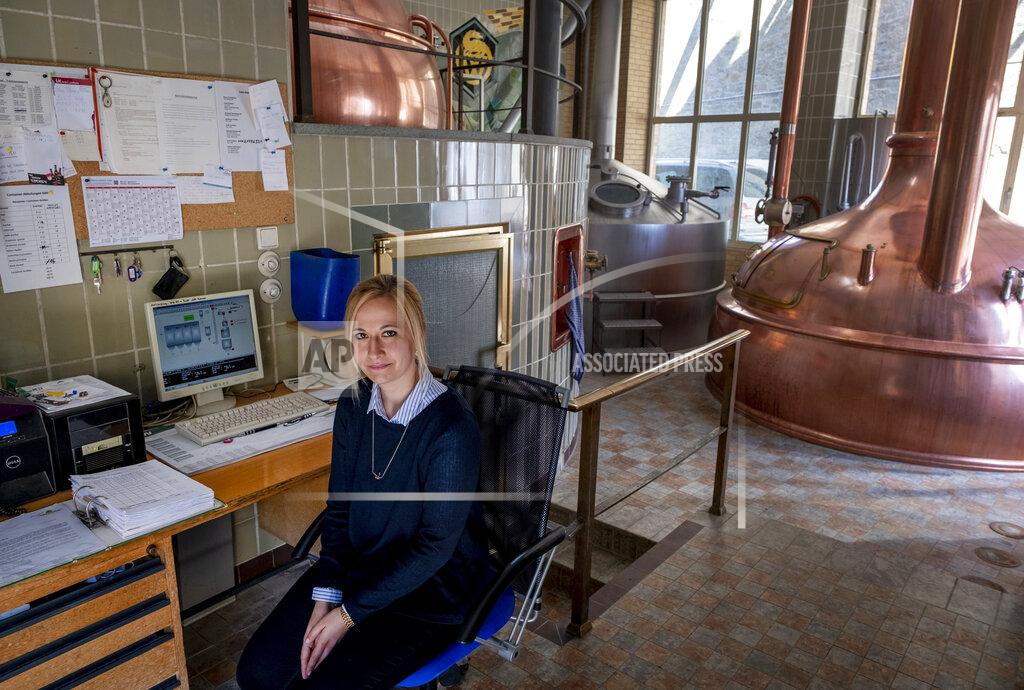 Michael Probst In this , Friday, April 17, 2020 photo junior director Christine Lang of the "Wernecker brewery" sits in the brewhouse of the brewery in Werneck, Germany. Due to the impact of the coronavirus the traditional brewery has to close 400 years after its foundation. (AP Photo/Michael Probst)