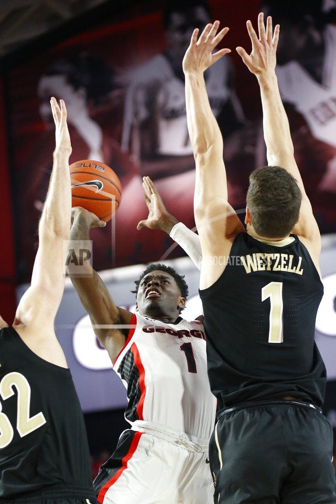 Joshua L. Jones Georgia guard Teshaun Hightower (1) takes a shot over Vanderbilt forward-center Yanni Wetzell (1) during an NCAA college basketball game, Wednesday, Jan. 9, 2019 in Athens, Ga. (Joshua L. Jones/Athens Banner-Herald via AP)