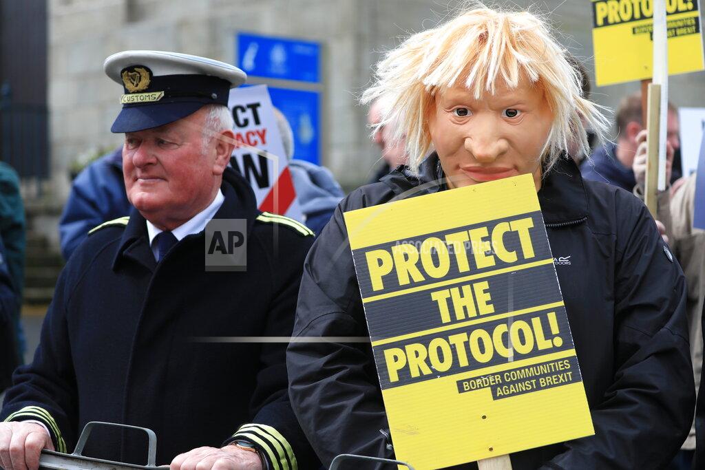 Peter Morrison Demonstrators protest outside Hillsborough Castle, ahead of a visit by British Prime Minister Boris Johnson, in Hillsborough, Northern Ireland, Monday, May, 16, 2022. Johnson on Monday renewed British threats to break a Brexit agreement with the European Union, blaming it for a political crisis that's blocking the formation of a new government in Northern Ireland. (AP Photo/Peter Morrison)