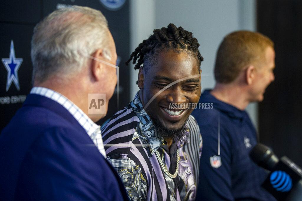 Shaban Athuman Dallas Cowboys CEO Stephen Jones, left, shares a moment with defensive end Demarcus Lawrence as Cowboys owner Jerry Jones gives remarks during a press conference at The Star in Frisco, Texas, Tuesday, April 9, 2019. DeMarcus Lawrence may not be the highest-paid Dallas Cowboys player in history for long. It doesn’t mean the club’s best defensive end can’t enjoy the distinction while it lasts. The 26-year-old Lawrence signed a $105 million, five-year contract Tuesday.(Shaban Athuman/The Dallas Morning News via AP)