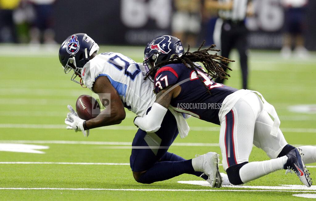 Michael Wyke Tennessee Titans wide receiver Corey Davis, left, catches a pass as Houston Texans strong safety Jahleel Addae (37) defends during the first half of an NFL football game Sunday, Dec. 29, 2019, in Houston. (AP Photo/Michael Wyke)