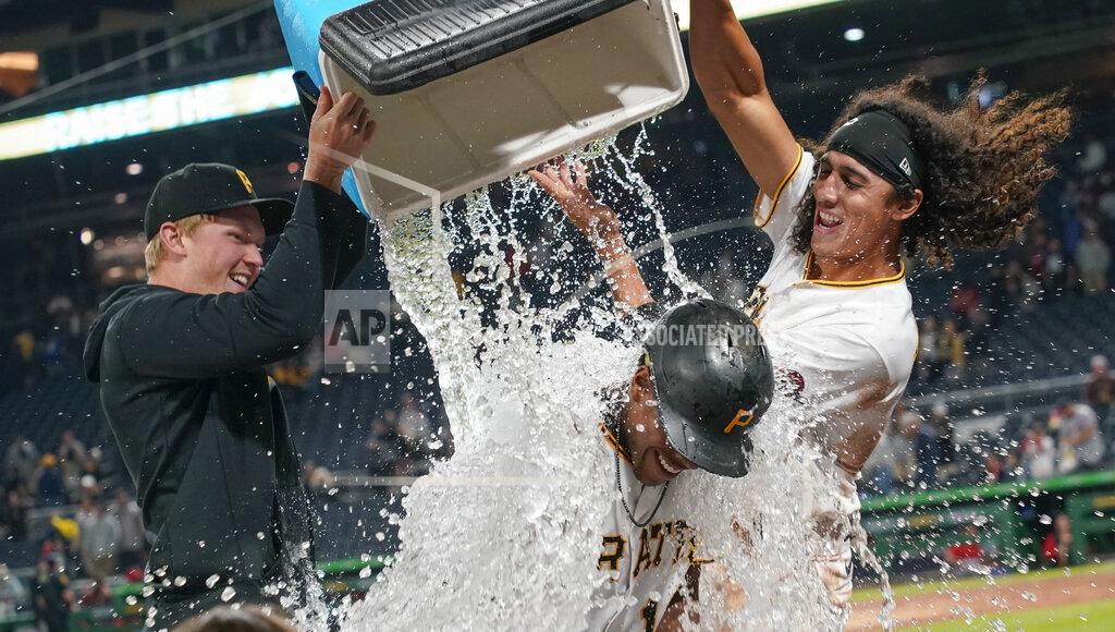 Keith Srakocic Pittsburgh Pirates' Ke'Bryan Hayes, bottom, has a chest of ice and water dumped onto him in celebration by Cole Tucker, right, and Mitch Keller, left, after Hayes drove in the winning run in the team's baseball game against the Washington Nationals, Friday, Sept. 10, 2021, in Pittsburgh. The Pirates won 4-3. (AP Photo/Keith Srakocic)