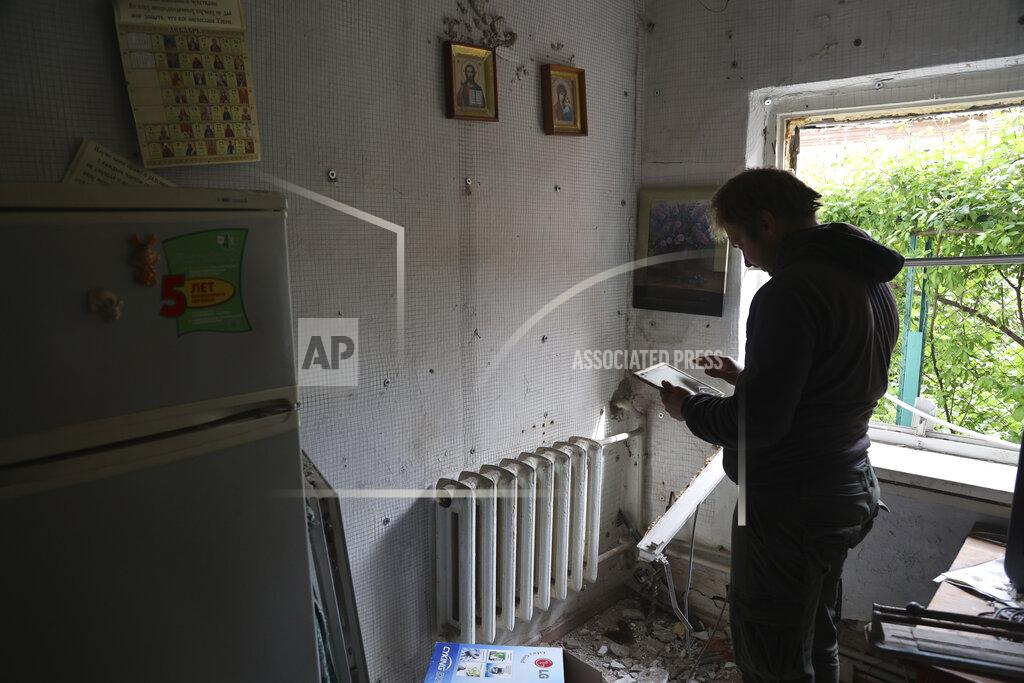 Alexei Alexandrov A man stands in a house damaged by shelling in Mariupol, in territory under the government of the Donetsk People's Republic, eastern Ukraine, Saturday, May 21, 2022. (AP Photo/Alexei Alexandrov)