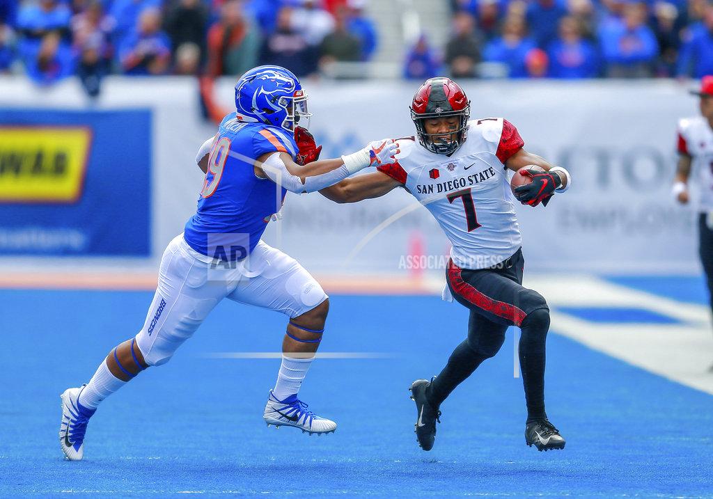 Steve Conner San Diego State wide receiver Fred Trevillion, right, stiff arms Boise State linebacker Curtis Weaver, left, after a reception in the first half of an NCAA college football game, Saturday, Oct. 6, 2018, in Boise, Idaho. (AP Photo/Steve Conner)