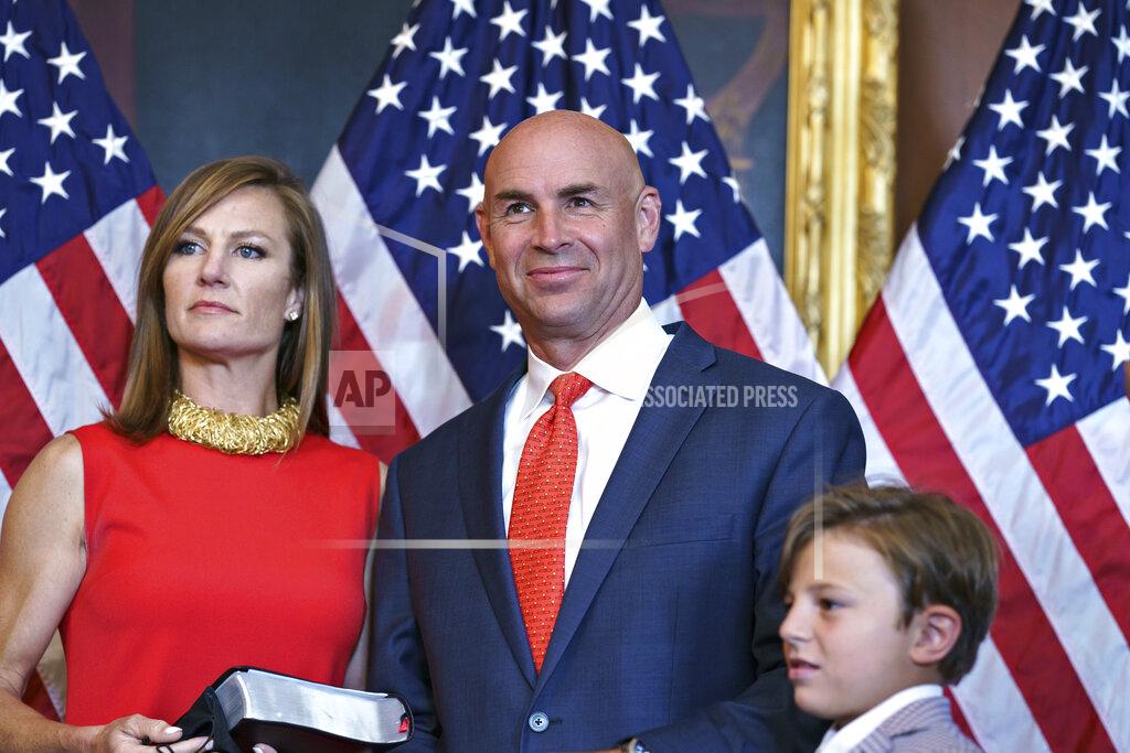 J. Scott Applewhite Rep. Jake Ellzey, R-Texas, joined by his wife Shelby, left, center, and their children, are seen after his wearing-in ceremony, at the Capitol in Washington, Friday, July 30, 2021. Ellzey won a special election in Texas's 6th congressional district which represents three counties just south of the Dallas-Fort Worth metropolitan region. (AP Photo/J. Scott Applewhite)