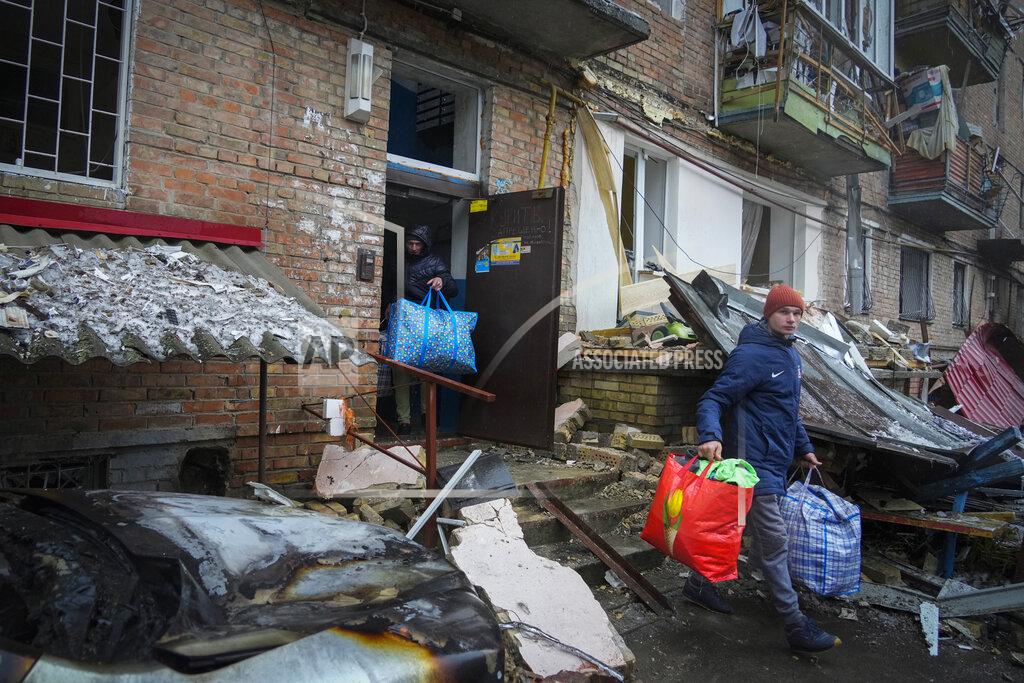 Efrem Lukatsky People gather their belongings from a damaged house after Russian shelling in the town of Vyshgorod outside the capital Kiev, Ukraine, Thursday, Nov. 24, 2022. About 70% of the Ukrainian capital was left without power on Thursday morning after Moscow unleashed yet another devastating missile barrage on Ukraine's energy infrastructure, Kyiv's mayor said. (AP Photo/Efrem Lukatsky)