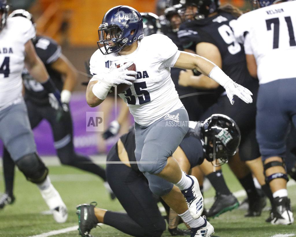 Marco Garcia Nevada running back Toa Taua (35) breaks through a Hawaii defense during the third quarter at an NCAA college football game Saturday, Oct. 20, 2018, in Honolulu. (AP Photo/Marco Garcia)