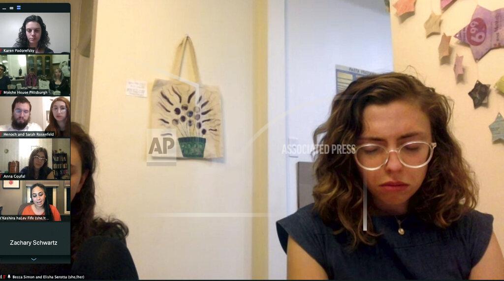 Jessie Wardarski In this Oct. 22, 2020 image from a video conference, Becca Simon closes her eyes as she prays and meditates with 37 other community members during a virtual roundtable held to commemorate and reflect on the 2018 mass shooting at the Tree of Life synagogue in Pittsburgh. Tuesday, Oct. 27, 2020, marks two years since 11 people were killed while worshipping at the synagogue. (AP Photo)