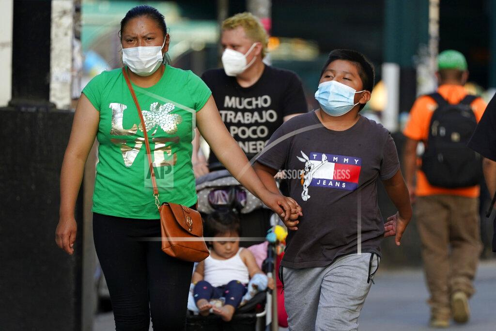 Frank Franklin Ii FILE — In this May 19, 2021 file photo. pedestrians wear protective masks during the coronavirus pandemic, in the Queens borough of New York. New York Gov. Andrew Cuomo and New York City Mayor Bill de Blasio have scheduled competing news conferences Monday, Aug. 2 amid rising COVID-19 case counts attributed to the highly contagious delta variant of the virus. (AP Photo/Frank Franklin II, File)