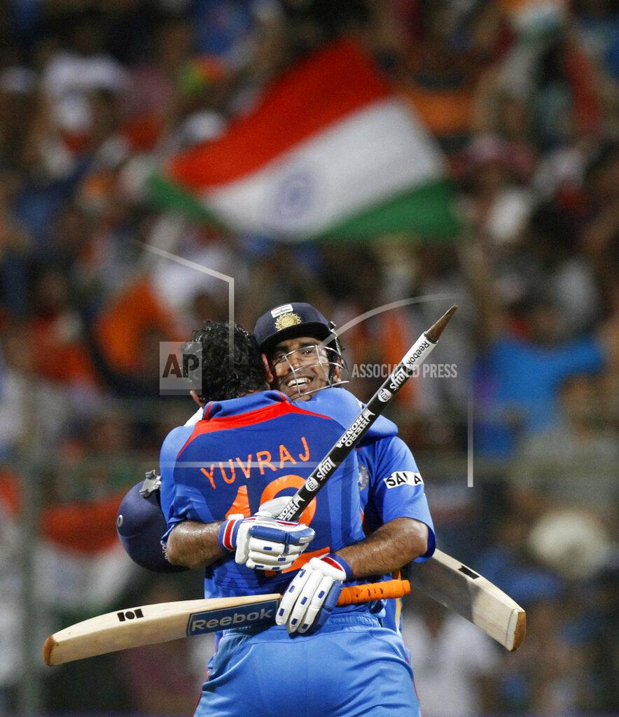 Gurinder Osan FILE - In this April 2, 2011, file photo, Indian cricket captain Mahendra Singh Dhoni, facing camera, and Yuvraj Singh, celebrate after winning the Cricket World Cup final match against Sri Lanka in Mumbai, India. India great Dhoni announced his retirement from international cricket on Saturday, Aug. 15, 2020. Under Dhoni’s stewardship, India won the T20 World Cup in 2007, the 50-over World Cup in 2011 and the Champions Trophy in 2013. (AP Photo/Gurinder Osan, File)
