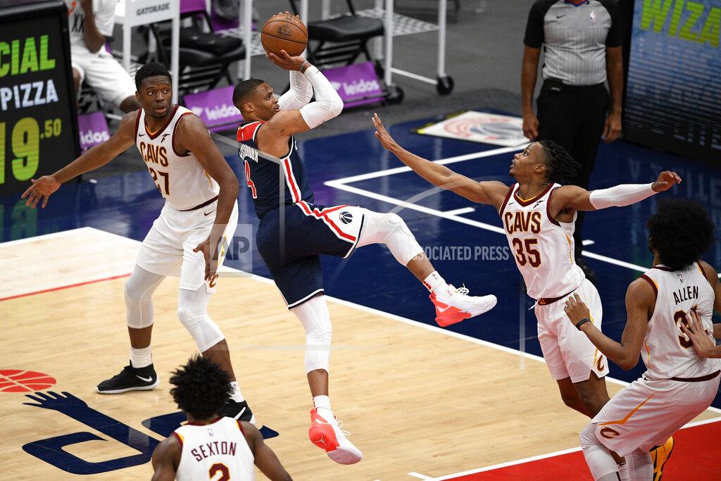 Nick Wass Washington Wizards guard Russell Westbrook (4) shoots against Cleveland Cavaliers forward Isaac Okoro (35), forward Mfiondu Kabengele (27), center Jarrett Allen (31) and guard Collin Sexton (2) during the second half of an NBA basketball game Friday, May 14, 2021, in Washington. (AP Photo/Nick Wass)