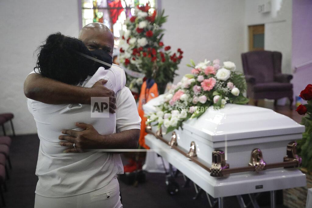 Marcio Jose Sanchez FILE - In this July 21, 2020, file photo, Darryl Hutchinson, facing camera, is hugged by a relative during a funeral service for Lydia Nunez, who was Hutchinson's cousin at the Metropolitan Baptist Church in Los Angeles. Nunez died from COVID-19. Southern California funeral homes are turning away bereaved families because they're running out of space for the bodies piling up during an unrelenting coronavirus surge. (AP Photo/Marcio Jose Sanchez, File)