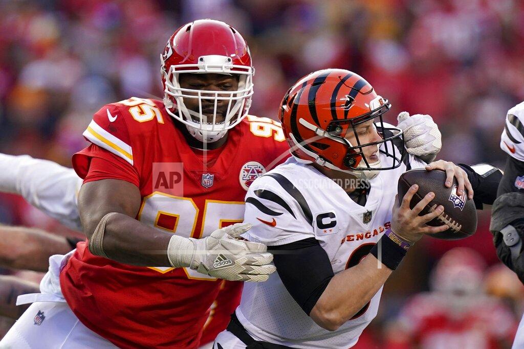Eric Gay Cincinnati Bengals quarterback Joe Burrow (9) breaks a tackle attempt by Kansas City Chiefs defensive end Chris Jones (95) during the second half of the AFC championship NFL football game, Sunday, Jan. 30, 2022, in Kansas City, Mo. (AP Photo/Eric Gay)