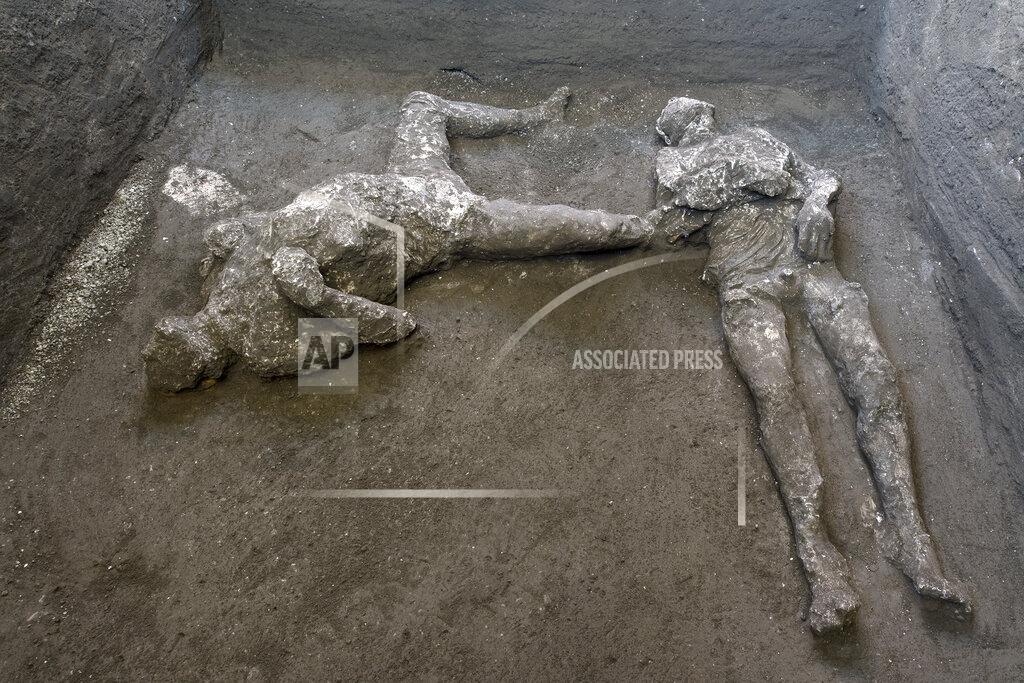 Uncredited The casts of what are believed to have been a rich man and his male slave fleeing the volcanic eruption of Vesuvius nearly 2,000 years ago, are seen in what was an elegant villa on the outskirts of the ancient Roman city of Pompeii destroyed by the eruption in 79 A.D., where they were discovered during recents excavations, Pompeii archaeological park officials said Saturday, Nov. 21, 2020. (Parco Archeologico di Pompei via AP)