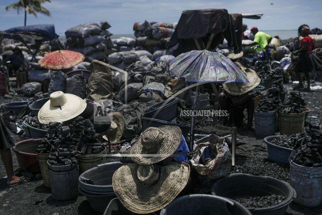 Matias Delacroix Vendors wear hats for shade as they sell cooking coal at a market in Cap-Haitien, Haiti, Thursday, July 22, 2021. The city of Cap-Haitien will hold events to honor slain President Jovenel Moïse on Thursday ahead of Friday’s funeral. (AP Photo/Matias Delacroix)