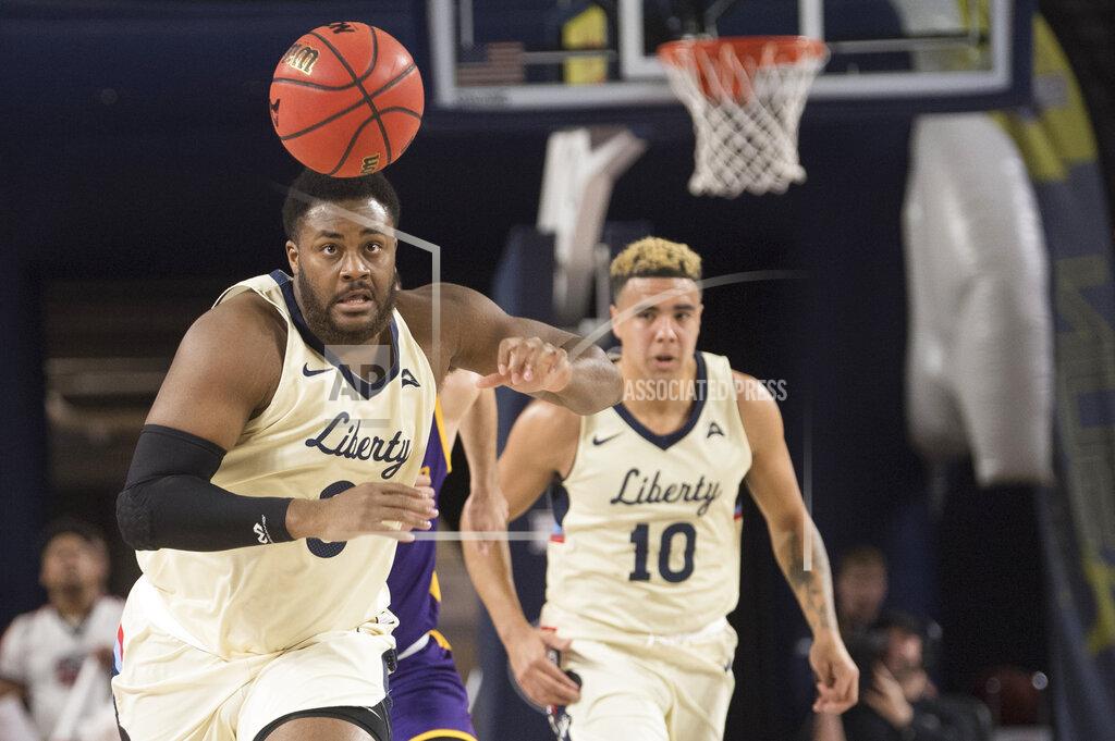 Lee Luther Jr. Liberty forward Myo Baxter-Bell, left, chases after ball during the first half against Lipscomb in the Atlantic Sun conference NCAA basketball championship game in Lynchburg, Va., Sunday, March 8, 2020. (AP Photo/Lee Luther Jr.)