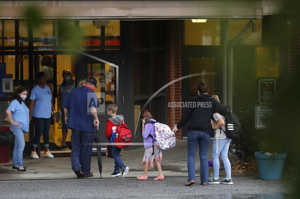 Brynn Anderson Students arrive to Dallas Elementary School for the first day of school amid the coronavirus outbreak on Monday, Aug. 3, 2020, in Dallas, Ga. (AP Photo/Brynn Anderson)