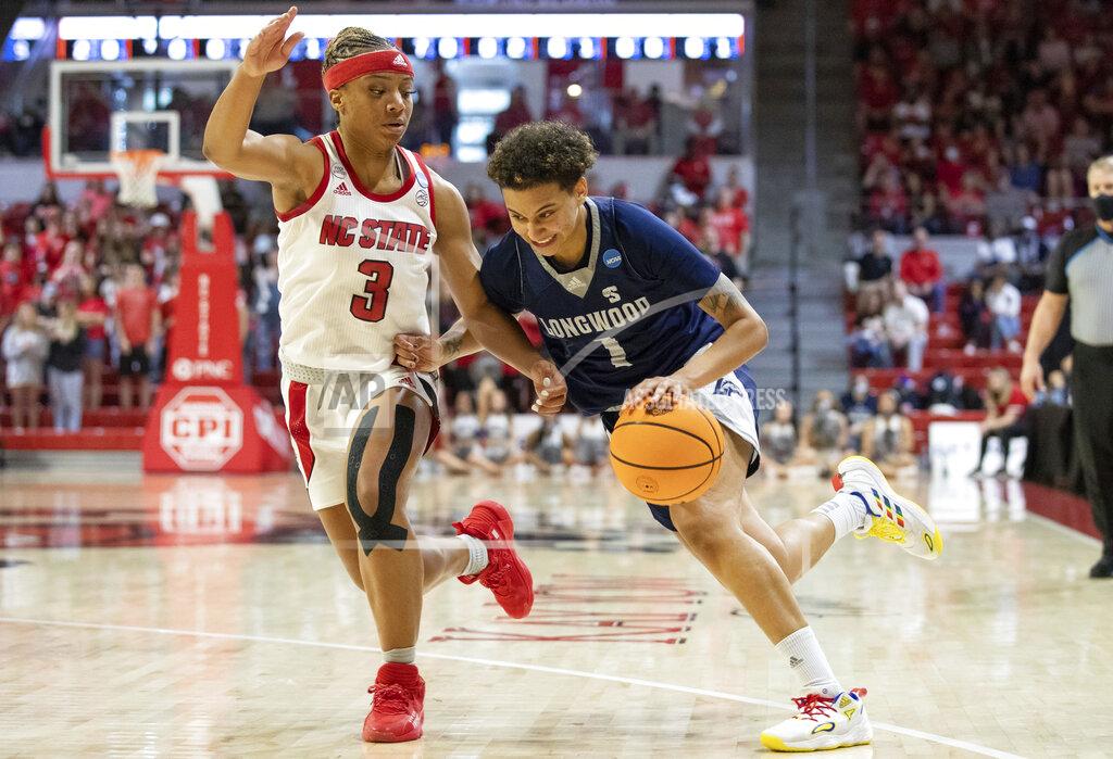 Ben Mckeown Longwood's Kyla McMakin (1) drives against North Carolina State's Kai Crutchfield (3) during the first half of a college basketball game in the first round of the NCAA tournament in Raleigh, N.C., Saturday, March 19, 2022. (AP Photo/Ben McKeown)