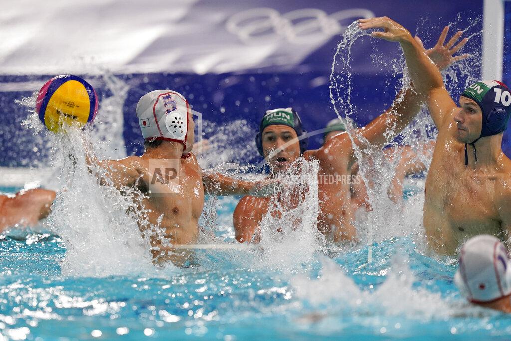 Mark Humphrey Japan's Takuma Yoshida (5) winds up to shoot against Hungary's Denes Varga (10) during a preliminary round men's water polo match at the 2020 Summer Olympics, Tuesday, July 27, 2021, in Tokyo, Japan. (AP Photo/Mark Humphrey)