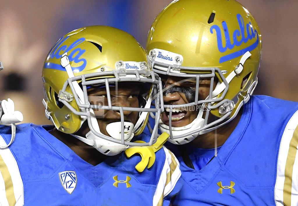 Mark J. Terrill UCLA wide receiver Demetric Felton, left, celebrates his touchdown with tight end Devin Asiasi during the second half of an NCAA college football game against Arizona Saturday, Oct. 20, 2018, in Pasadena, Calif. UCLA won 31-30. (AP Photo/Mark J. Terrill)