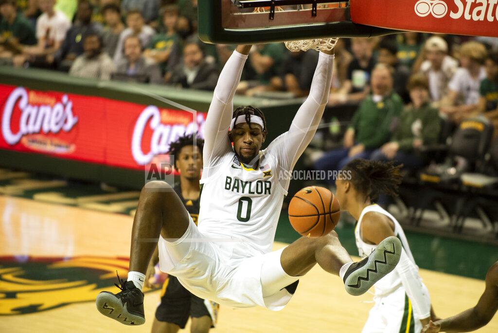 Emil Lippe Baylor forward Flo Thamba (0) throws down a slam dunk in the second half of an NCAA college basketball game in Waco, Texas, Saturday, Dec. 4, 2021. (AP Photo/Emil Lippe)
