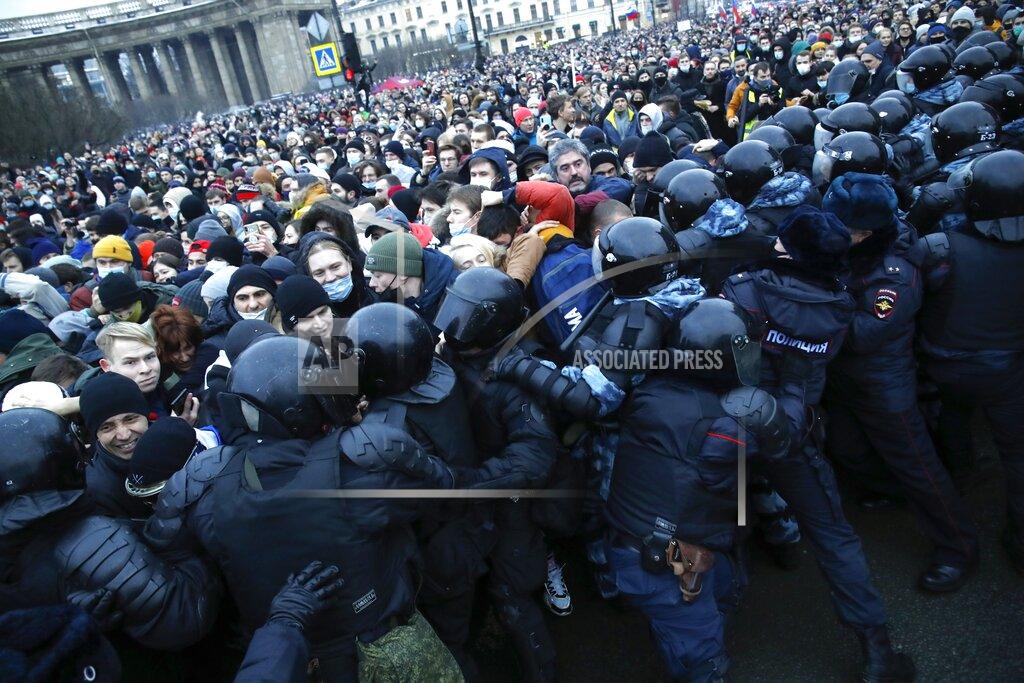 Dmitri Lovetsky People clash with police during a protest against the jailing of opposition leader Alexei Navalny in St.Petersburg, Russia, Saturday, Jan. 23, 2021. Russian police on Saturday arrested hundreds of protesters who took to the streets in temperatures as low as minus-50 C (minus-58 F) to demand the release of Alexei Navalny, the country's top opposition figure. A Navalny, President Vladimir Putin's most prominent foe, was arrested on Jan. 17 when he returned to Moscow from Germany, where he had spent five months recovering from a severe nerve-agent poisoning that he blames on the Kremlin. (AP Photo/Dmitri Lovetsky)