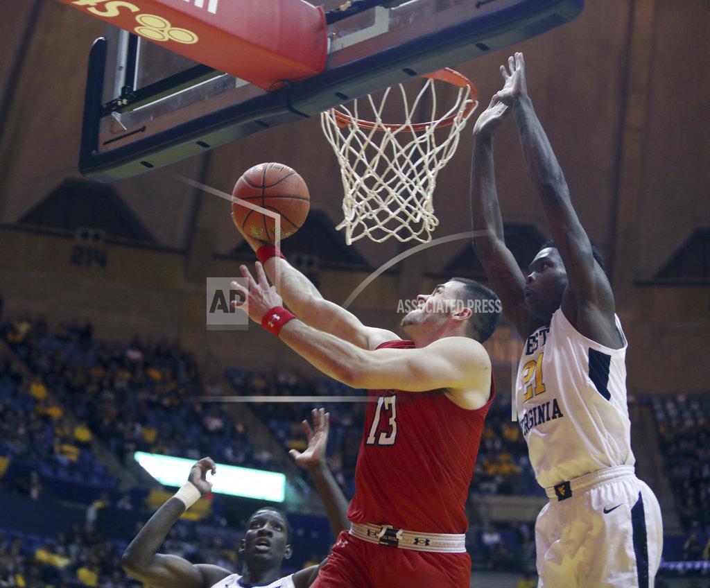 Ray Thompson Texas Tech guard Matt Mooney (13) drives to the basket while defended by West Virginia forward Wesley Harris (21) during the first half of an NCAA college basketball game Wednesday, Jan. 2, 2019, in Morgantown, W.Va. (AP Photo/Raymond Thompson)